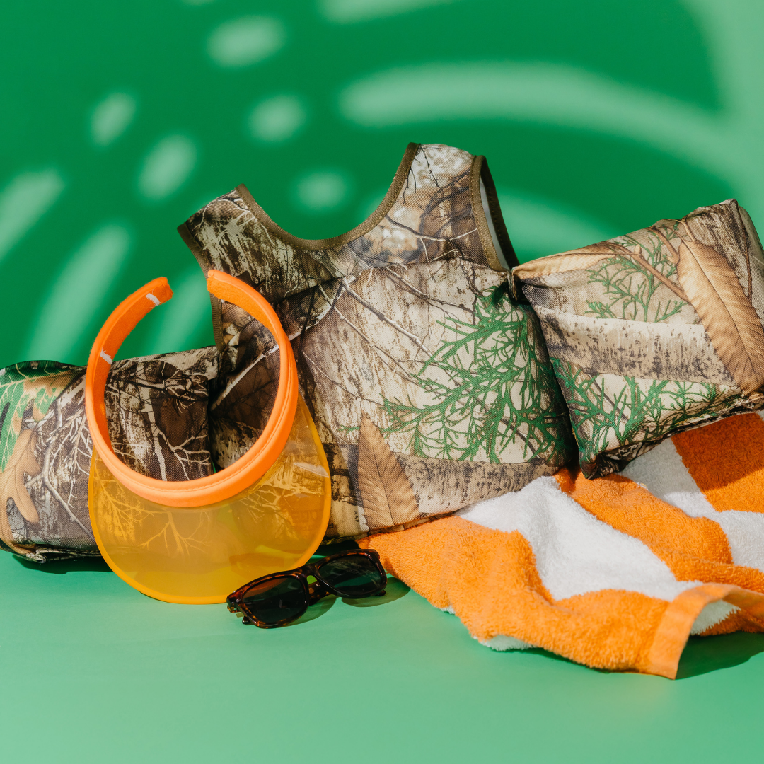 Realtree Edge Camo Kids Float with orange visor, sunglasses and pool towel