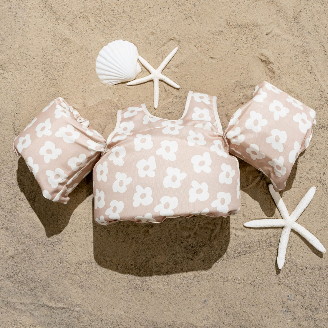 Flower Power Neutral Kids Float with taupe floral print on sand