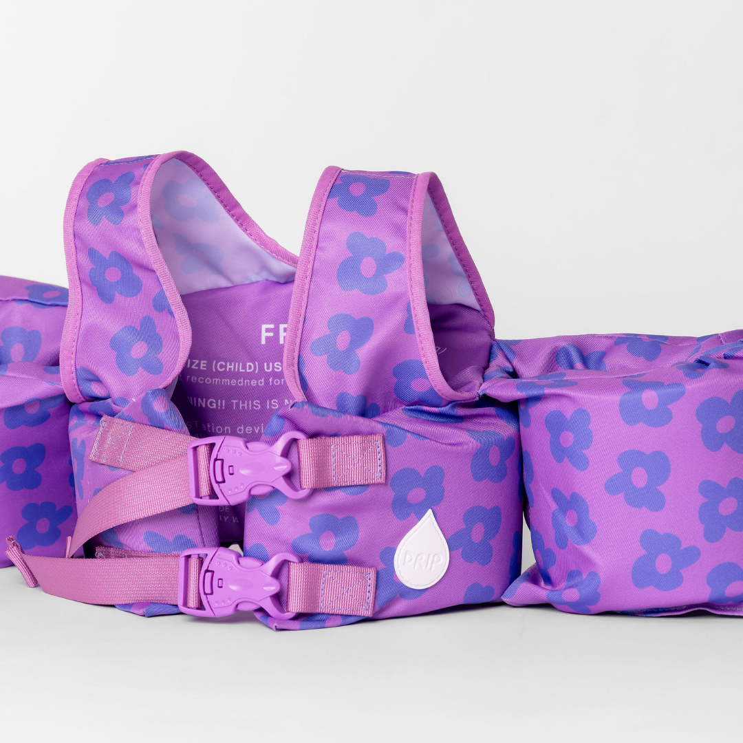 Purple Flower Power kids swim float with adjustable back straps, buckles and shoulder straps